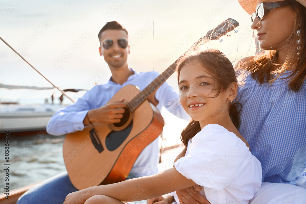 Happy young family resting on yacht Happy young family resting on yacht