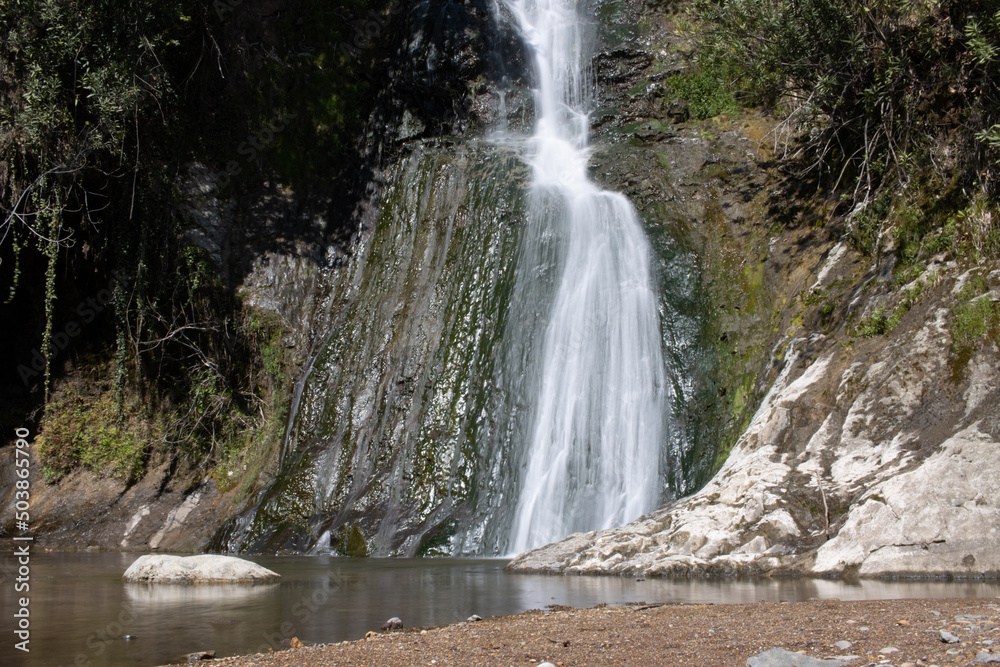 Fototapeta premium Beautiful and original panorama. Beautiful and majestic landscape and panorama of a mountain waterfall, a river, in textured and hard rocks and stones in the afternoon in the summer. High quality