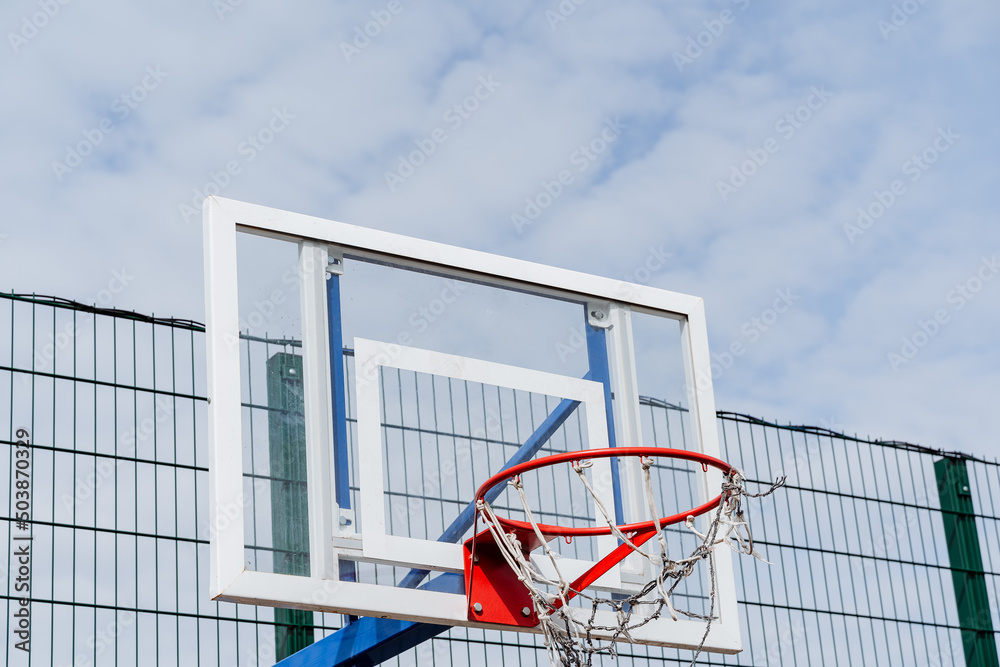 Basketball ring on the playground, transparent shield fiberglass for proska ball, torn net, play basketball outside