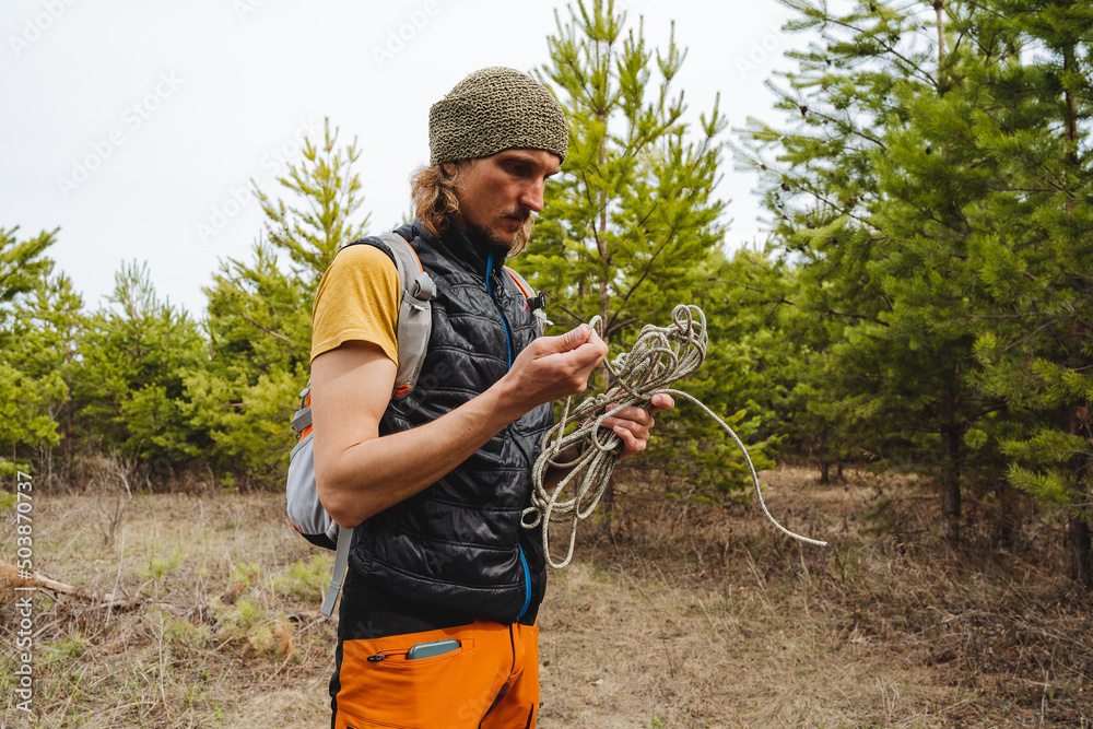 Untangling A Rope Untangling a rope, a man holding a coil of a strong rope in his hands ...