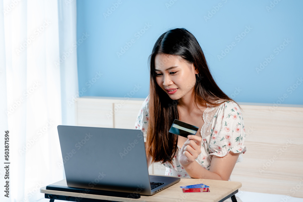 close-up of beautiful Asian girl in mobile credit card show great joy After using a credit card to make purchases that her like through the online system successfully. happy face close-up of beautiful Asian girl in mobile credit card show great joy After using a credit card to make purchases that her like through the online system successfully. happy face