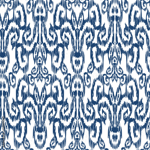 Seamless pattern - Tribal Art Ikat in traditional classic blue and white colors. Damascus - in Syrian Flower Pattern. Boho style. Printing on fabric. Ornamental plant pattern imitating weaving embroid