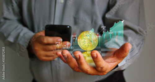 bitcoin with infographfic trend in business hand . investor using mobile phone searching bitcoin idea trend photo