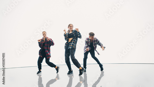 Bild auf Leinwand Diverse Group of Three Professional Dancers Performing a Hip Hop Dance Routine in Front of a Big Digital Led Wall Screen with Bright White Background in Studio Environment