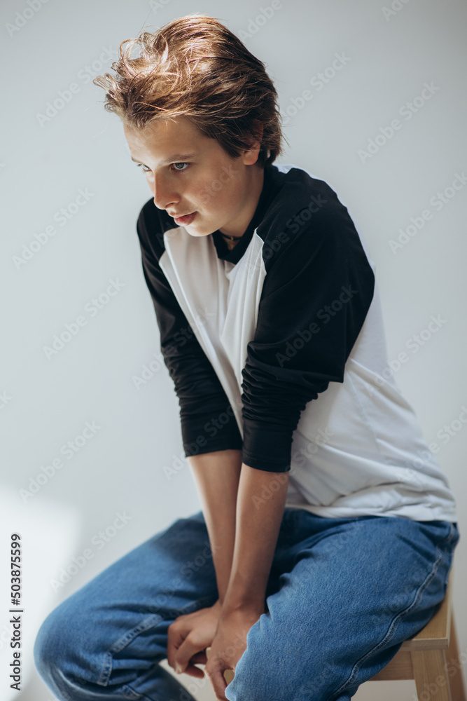 Portrait of a handsome teenage boy posing against a white background. Studio shot. Teenage fashion. High quality photo Portrait of a handsome teenage boy posing against a white background. Studio shot. Teenage fashion. High quality photo