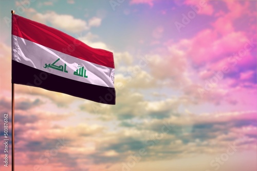 Fluttering Iraq flag mockup with the space for your content on colorful cloudy sky background. photo