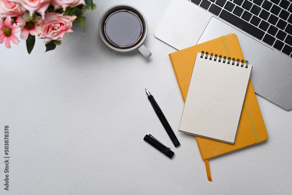 Blank notepad, coffee cup and computer laptop on white office desk. Flat lay. Blank notepad, coffee cup and computer laptop on white office desk. Flat lay.