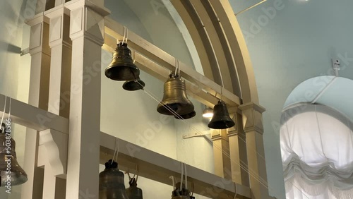 Ringing bells in Museum of Bells in Valdai. Music intstrument. Historical exhibition. Closeup. Centre Holy Trinity Cathedral. Sounding. Russian cultural heritage. Landmark. Bell casting. Bell ringer photo