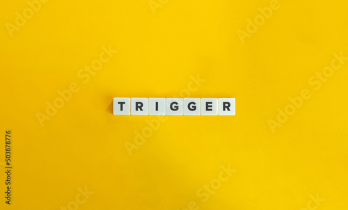 Trigger Word on Letter Tiles on Yellow Background. Minimal Aesthetics.