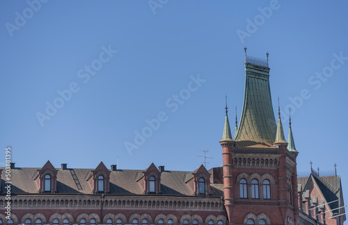 Roof of old office house with dorms and tower a sunny spring day in Stockholm
