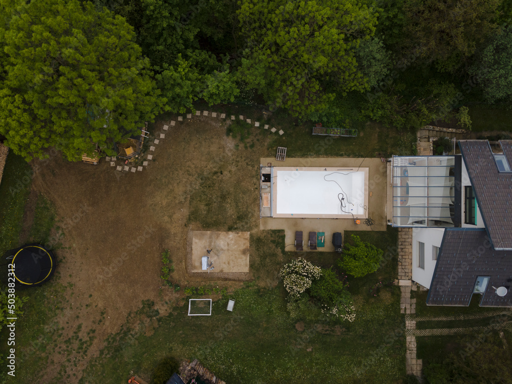 Drone flight over pool in the middle of greenery just left out and cleaned Drone flight over pool in the middle of greenery just left out and cleaned
