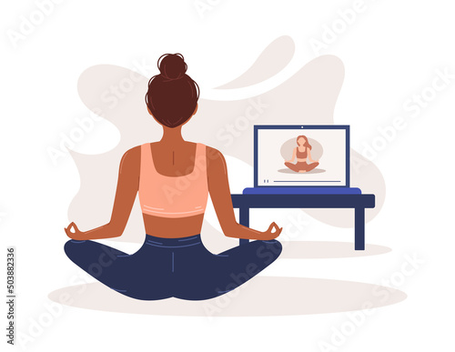 Online yoga. The girl does yoga and meditates at home online. Home sports. Harmony and meditation. Banner