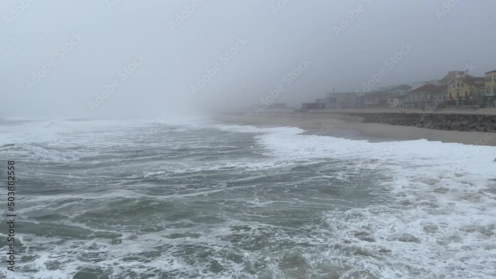 Waves, sea and coastal town of Furadouro, Atlantic ocean , Portugal. Grey foggy day Waves, sea and coastal town of Furadouro, Atlantic ocean , Portugal. Grey foggy day