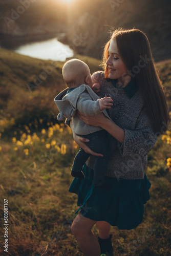 Woman and baby in nature. Mom and baby are relaxing in the park. High quality photo