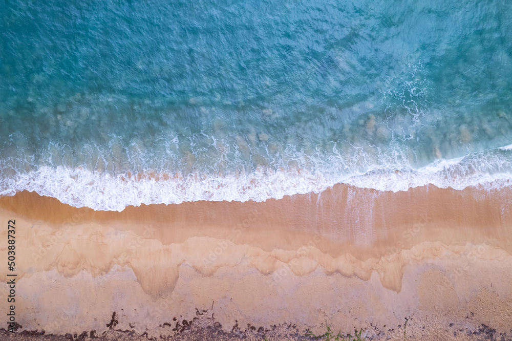 Aerial view sandy beach and waves Beautiful tropical sea in the morning summer season image by Aerial view drone shot, high angle view Top down sea waves