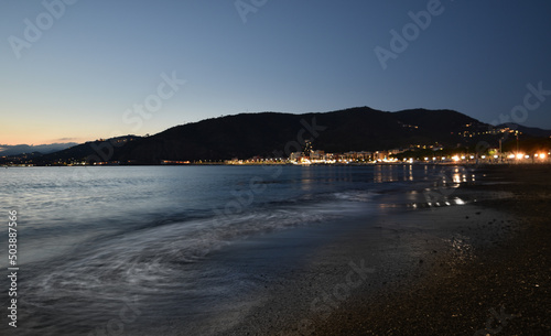 incredible colors and lights  a romantic sunset on the beach facing the sea in the magnificent Liguria