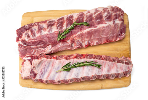 raw pork ribs with spices on cutting board. fresh pork ribs with rosemary on a wooden board, top view. Fresh meat and ingredients. Butchery, market