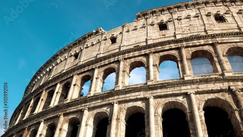 Roman Coliseum - ancient amphitheatre in the centre of the city of Rome against a blue sky on a sunny day, Italy