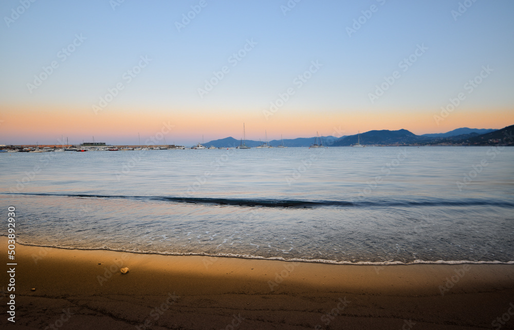incredible colors and lights, a romantic sunset on the beach facing the sea in the magnificent Liguria incredible colors and lights, a romantic sunset on the beach facing the sea in the magnificent Liguria