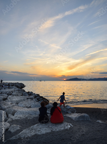 incredible colors and lights, a romantic sunset on the beach facing the sea in the magnificent Liguria © EcoPim-studio