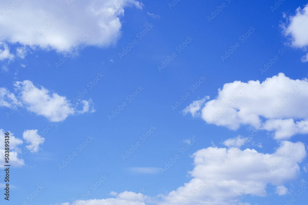 Light blue sky with four white clouds. Air, freshness and peace. Abstraction