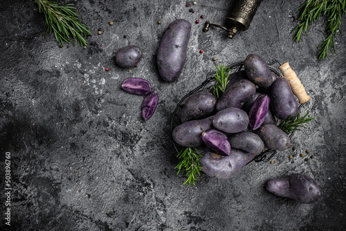 Organic purple sweet potato. Raw sweet potatoes or batatas. pomoea batatas. Batata potato. vegan food ingredient. banner, menu, recipe place for text, top view photo