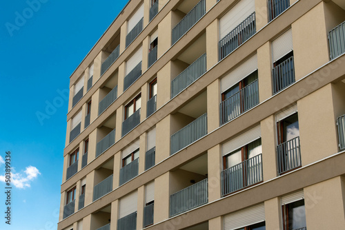 House facade with balconies and blue sky