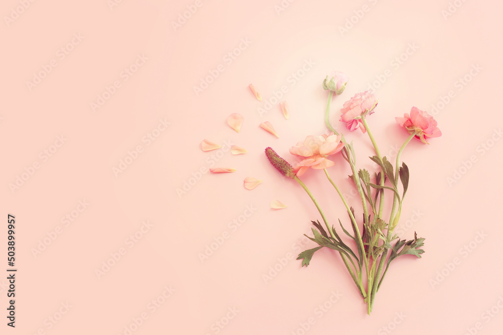 Fototapeta premium Top view image of pink flowers composition over pastel background