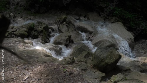 Closeup of water flow over rocks. Clean water flows over the rocks into the river. recorded at the Kedung Pedut Waterfall, Yogyakarta, Indonesia. photo