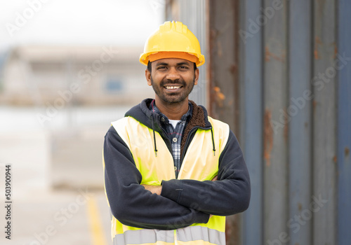 Canvas-taulu indian engineer man working in logistics at container port - migrant worker man