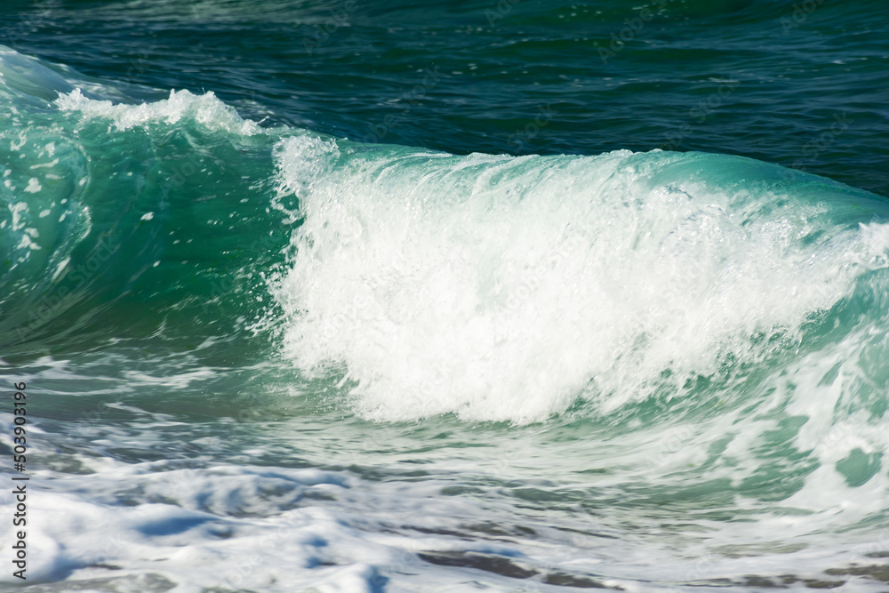 abstract sea background. green wave close up. blurry water in evening light abstract sea background. green wave close up. blurry water in evening light