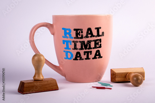 RTD REAL TIME DATA concept. Coffee cup with text on a white background photo