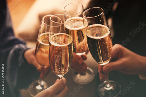 Slika na platnu People clinking glasses with sparkling wine indoors , closeup