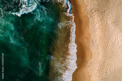 Top down aerial of deserted beach in Portugal captured from a drone