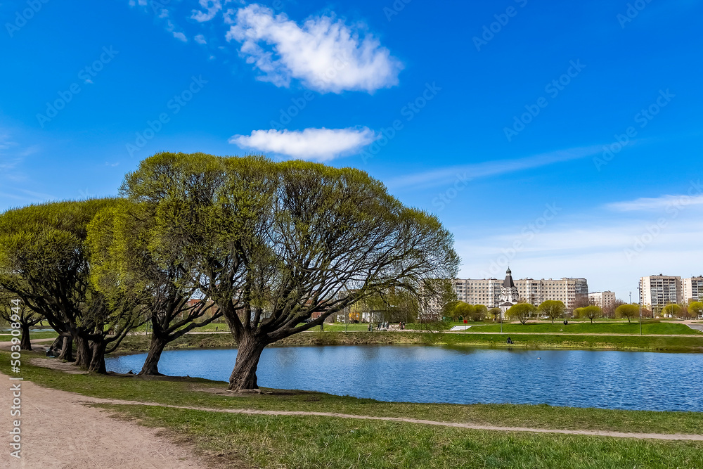 Saint Petersburg, Russia, May 10, 2022. Multi-storey modern residential buildings near the pond Saint Petersburg, Russia, May 10, 2022. Multi-storey modern residential buildings near the pond