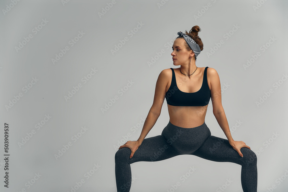 Fototapeta premium Beautiful pregnant woman workout. Doing fitness on last months of pregnancy. Yoga positions.