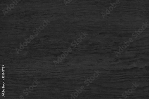 Black plywood surface texture. Dark wood grain backdrop. Abstract wooden pattern background