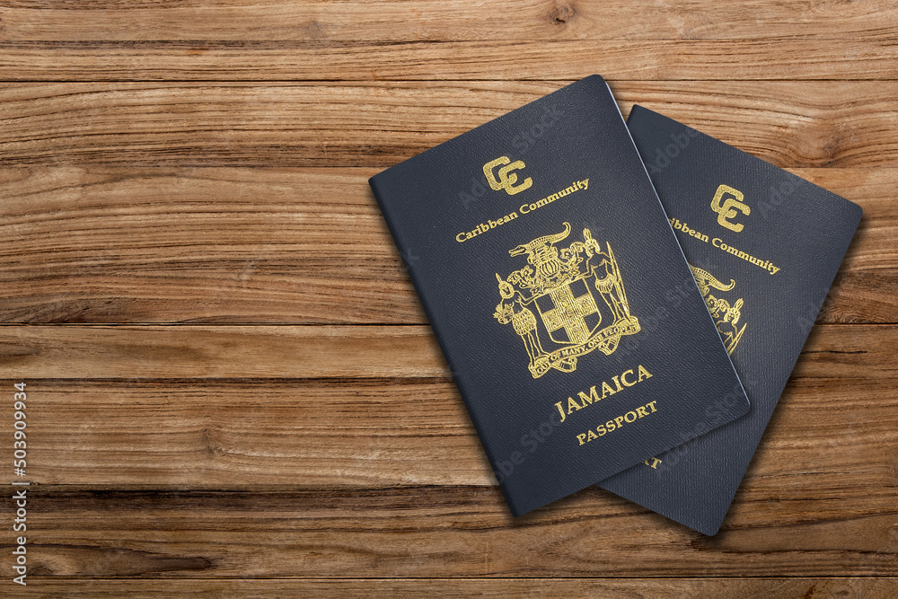 Jamaican passport on a wooden background ,The Jamaican passport is issued to citizens of Jamaica for international travel. Jamaican passport on a wooden background ,The Jamaican passport is issued to citizens of Jamaica for international travel.
