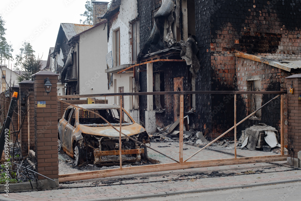 Fototapeta premium War of Russia against Ukraine. Burnt house and car in Bucha