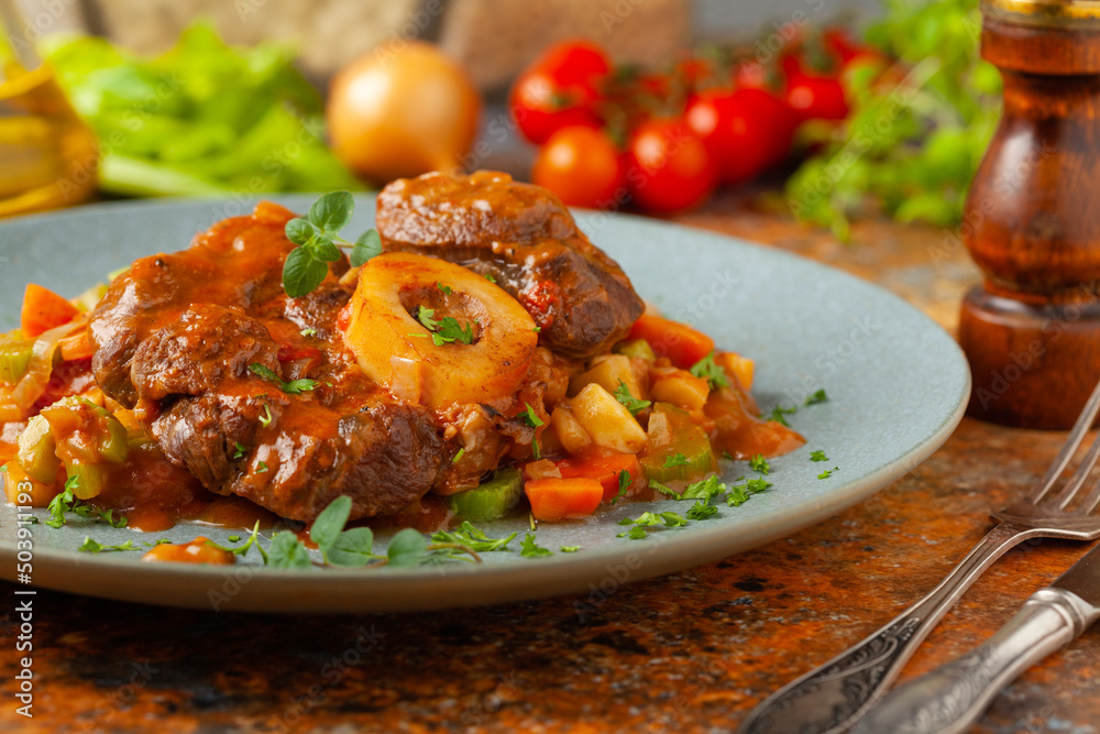 Ossobuco served with stewed vegetables. Ossobuco served with stewed vegetables.