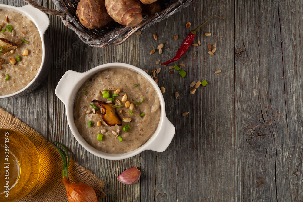 Soup, topinamburu cream. Served with croutons in gray bowls. Soup, topinamburu cream. Served with croutons in gray bowls.