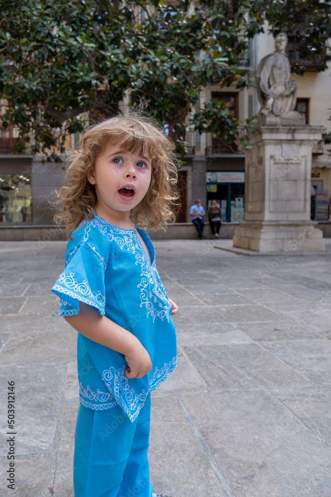 Beautiful blonde girl in arab costumes posing for camera in the streets of Granada, Spain Beautiful blonde girl in arab costumes posing for camera in the streets of Granada, Spain