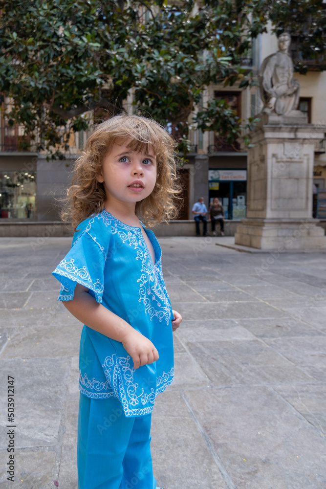 Beautiful blonde girl in arab costumes posing for camera in the streets of Granada, Spain Beautiful blonde girl in arab costumes posing for camera in the streets of Granada, Spain