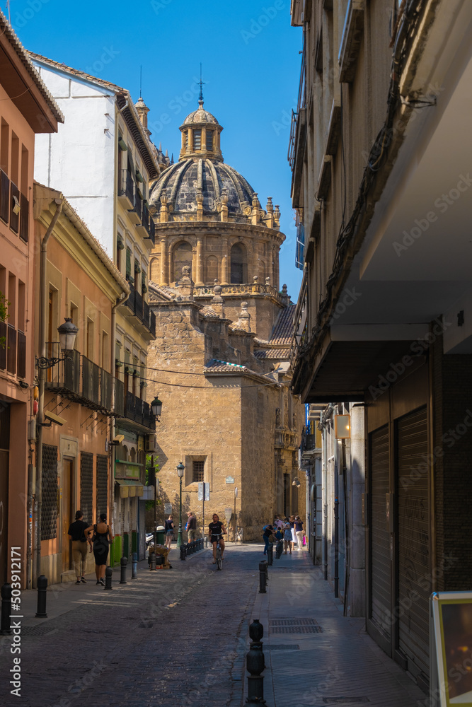 GRANADA, SPAIN - SEPTEMBER 25, 2021: View of tourists on streets of Granada with a church on background