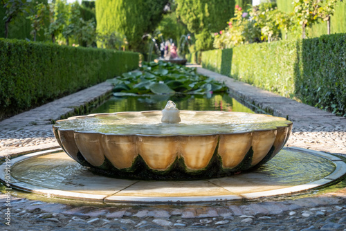 View of beautiful fountain from Alhambra gardens in Granada