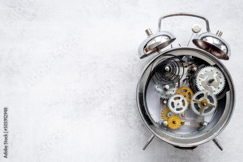 Open alarm clock with metal steel gears and wheels closeup