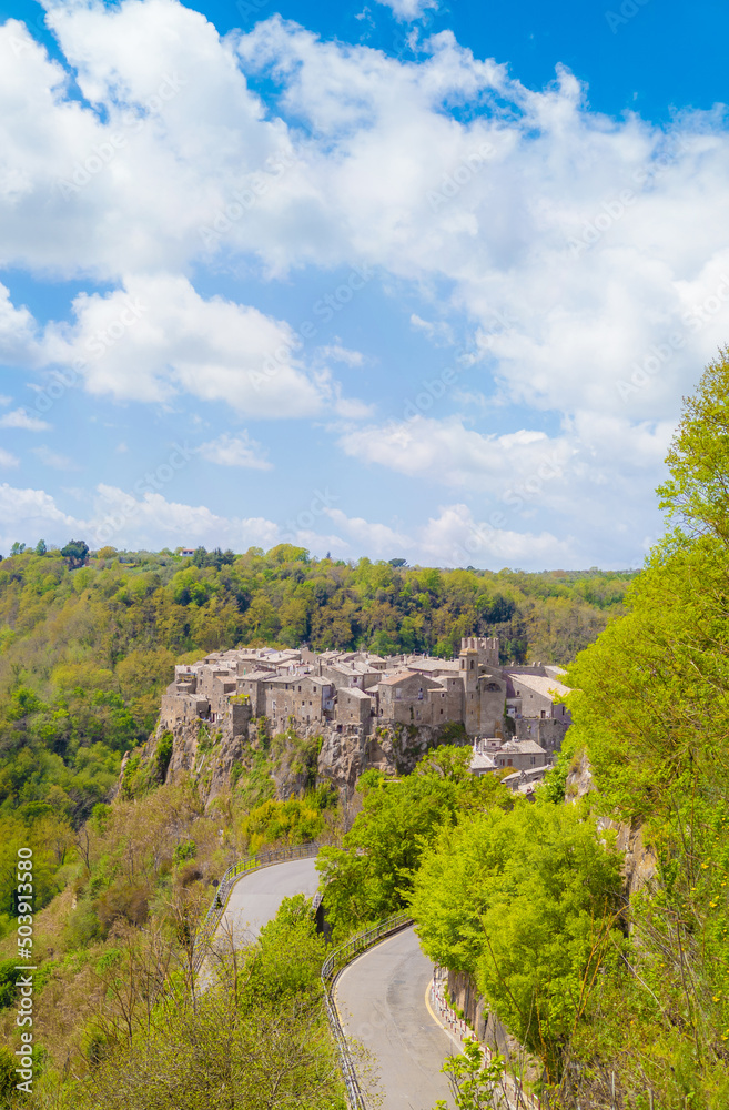 Fototapeta premium Calcata (Viterbo, Italy) - The old town of Calcata, perched on a mountain of tufa, overlooking the green Treja river valley, in Lazio region.