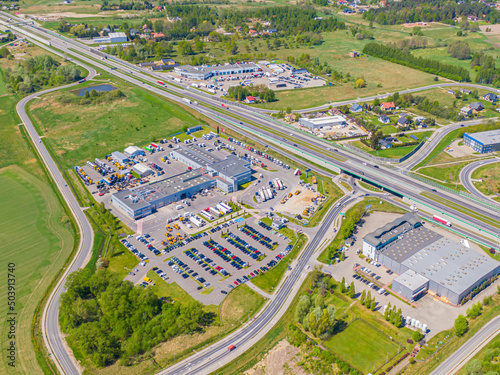 Aerial view of warehouse storages or industrial factory or logistics center from above. Top view of industrial buildings and trucks