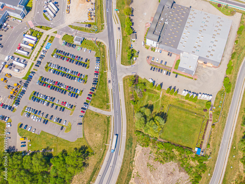 Aerial view of warehouse storages or industrial factory or logistics center from above. Top view of industrial buildings and trucks