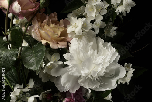 Fototapeta Naklejka Na Ścianę i Meble -  White peonies and roses on a black background, close-up, studio shot.